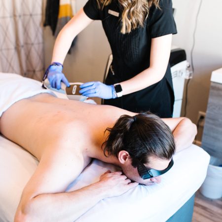 Men back laser hair removal in session