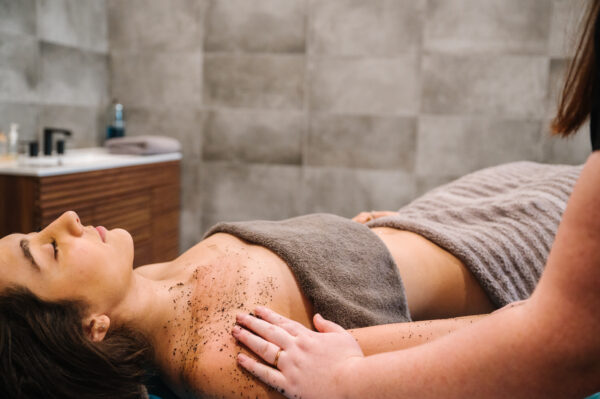 A woman enjoys a relaxing massage under a Vichy shower